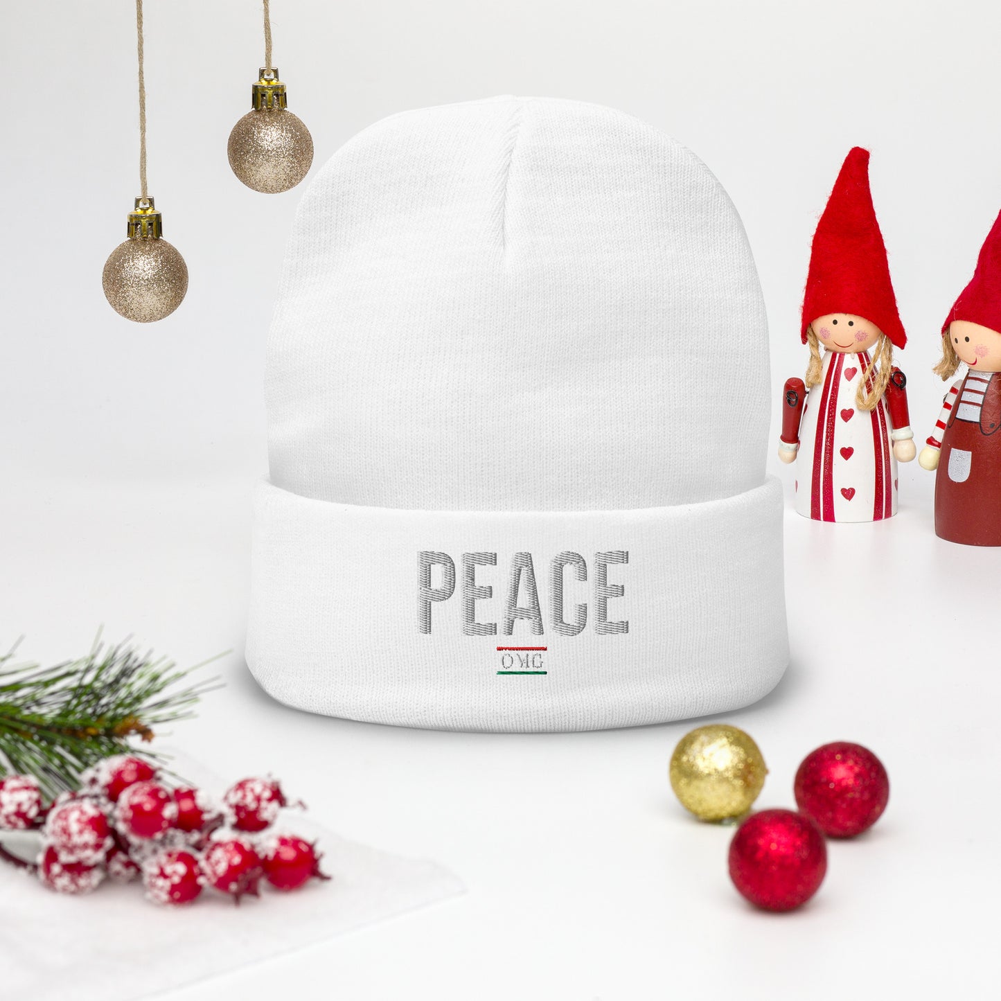 White snow globe with 'PEACE' text, surrounded by Christmas decorations on a white background